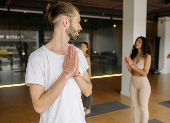 Diverse group of individuals practicing yoga poses.